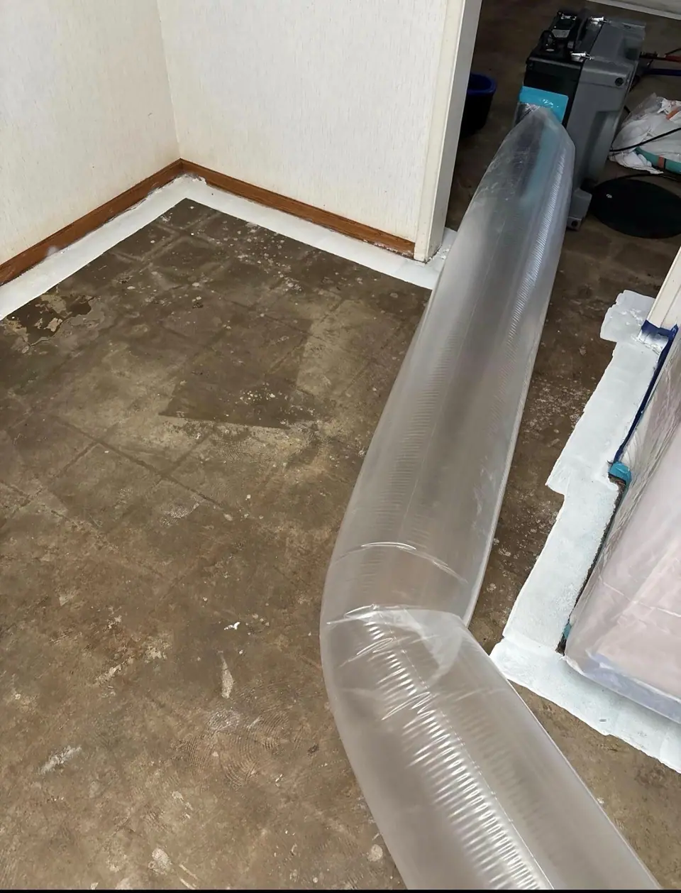 Lay-flat duct from an air scrubber running across a room under containment