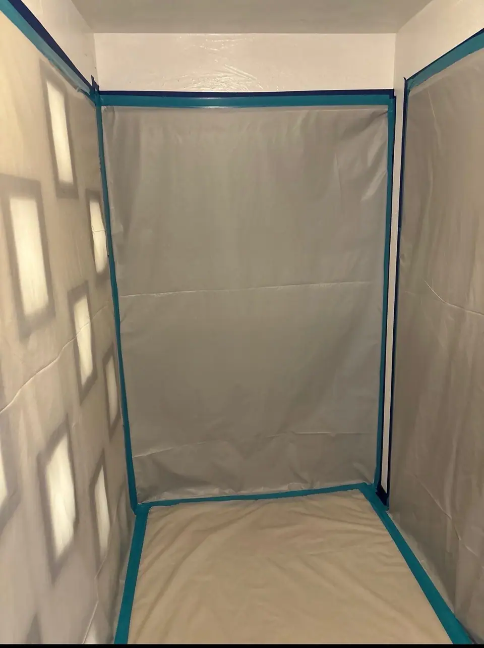 A sealed containment chamber of plastic sheeting and tape