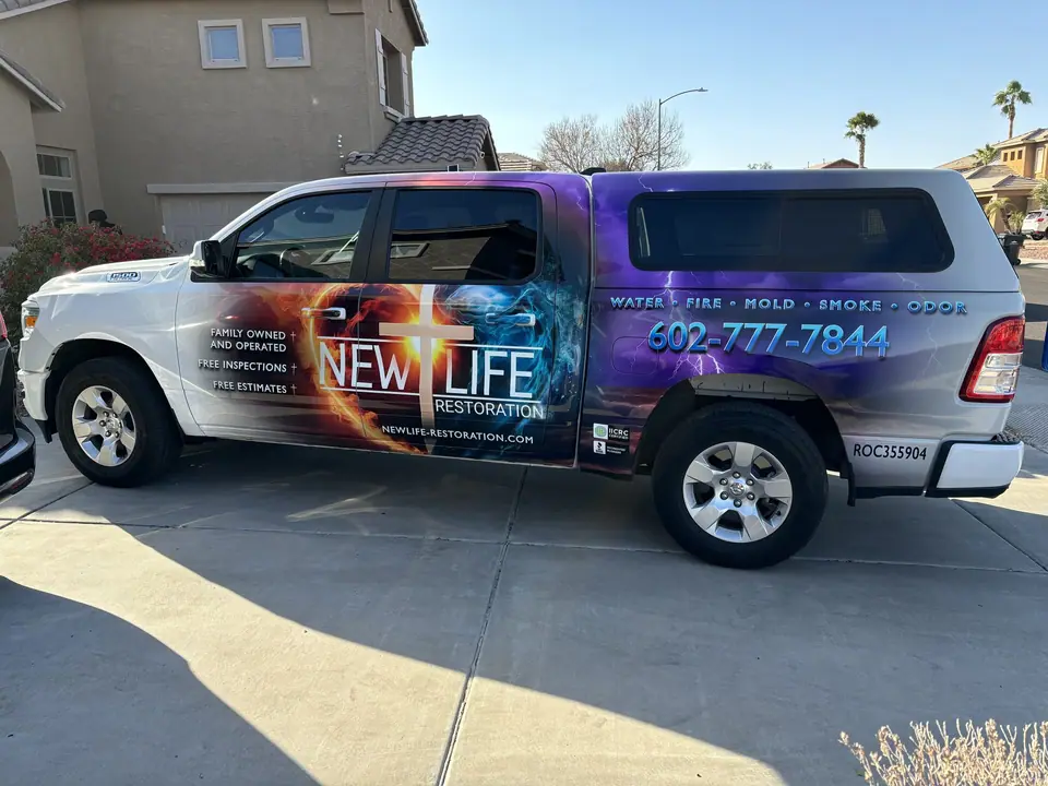 The New Life Restoration truck, wrapped with the same logo and phone number