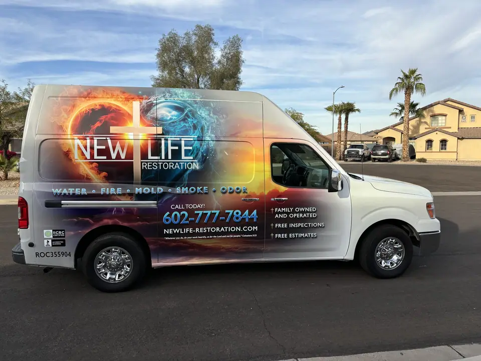 The New Life Restoration van, wrapped with the logo and phone number